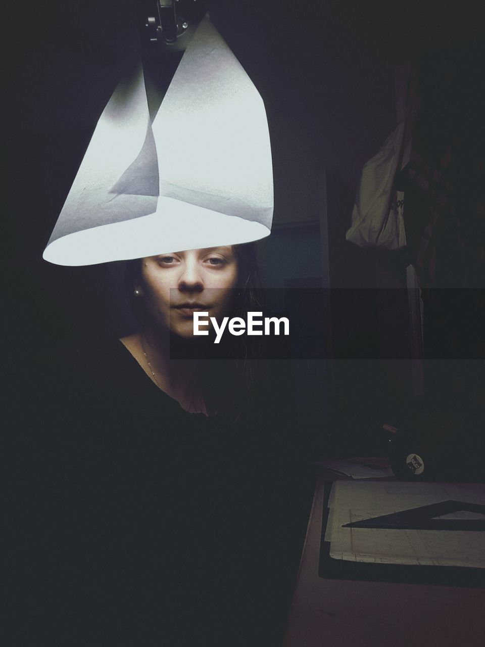 Portrait of woman sitting in darkroom at home