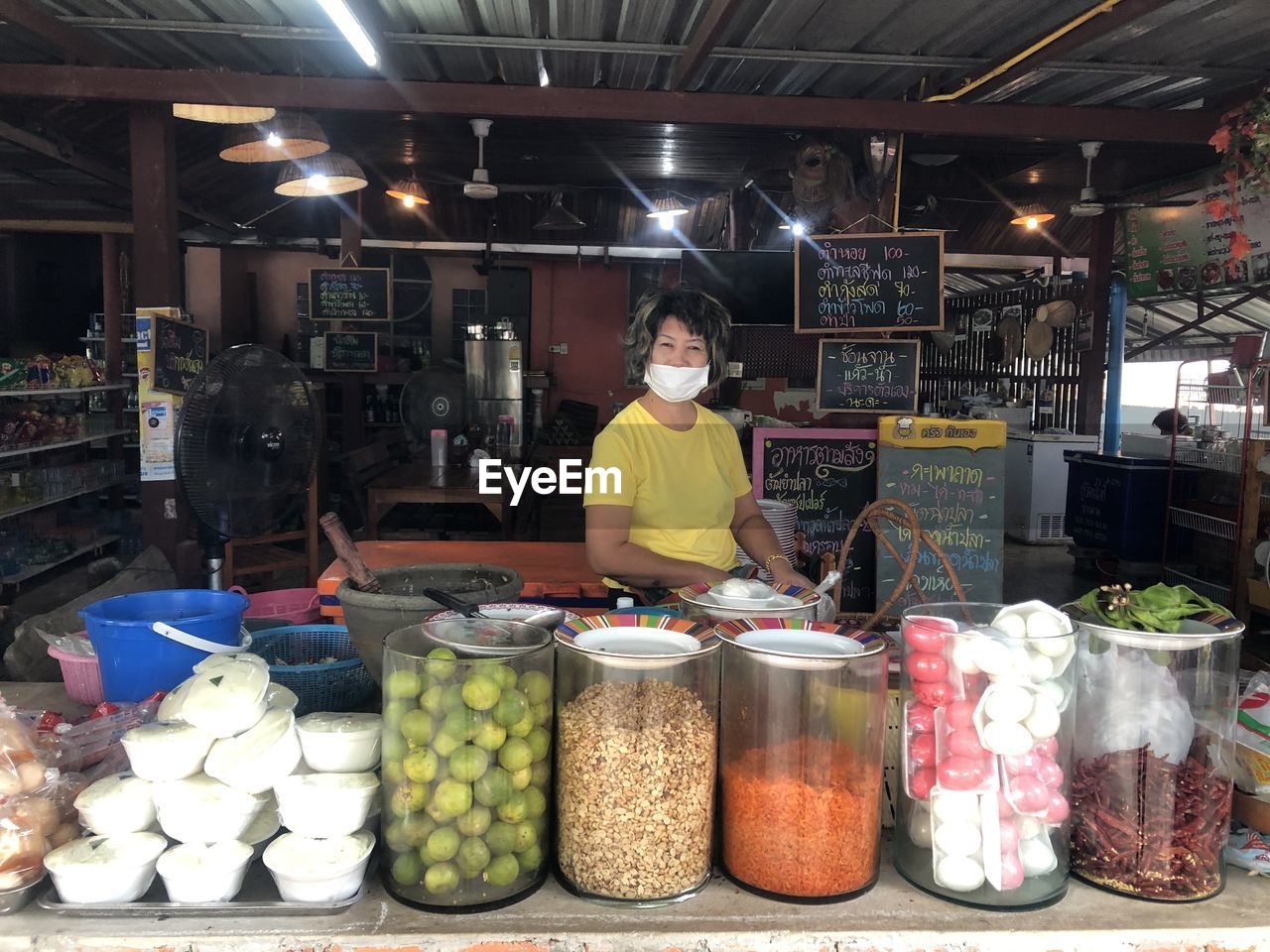 WOMAN STANDING IN MARKET