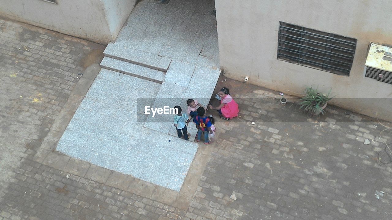 HIGH ANGLE VIEW OF PEOPLE WALKING ON STREET