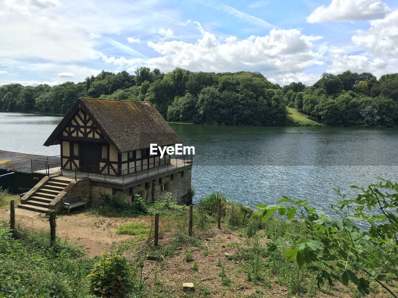 Calm lake with buildings in background