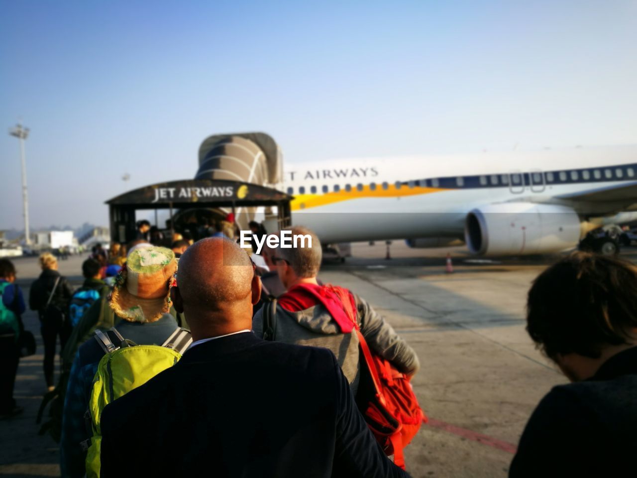 REAR VIEW OF PEOPLE IN AIRPORT