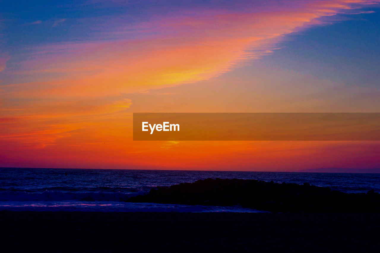 Scenic view of sea against sky at sunset