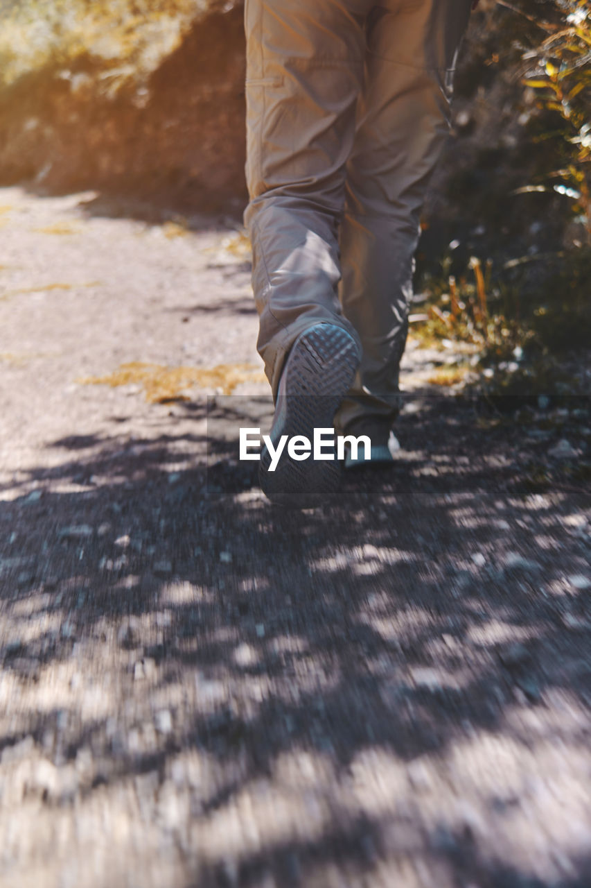 Young tourist walks on a path to the mountain. adventure travel, hiking concept.