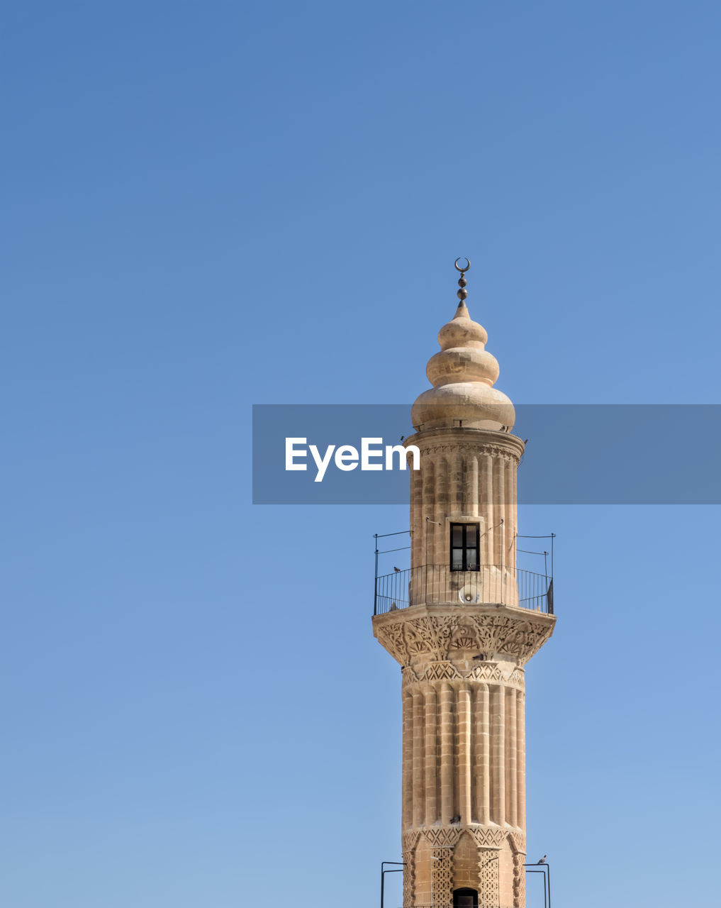 LOW ANGLE VIEW OF BELL TOWER AGAINST BLUE SKY