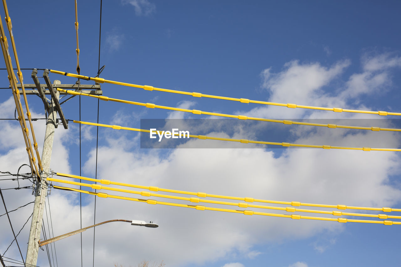 Low angle view of cables against blue sky