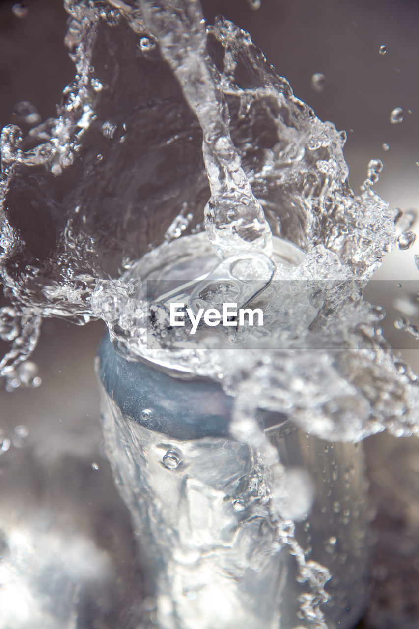 CLOSE-UP OF ICE SPLASHING WATER