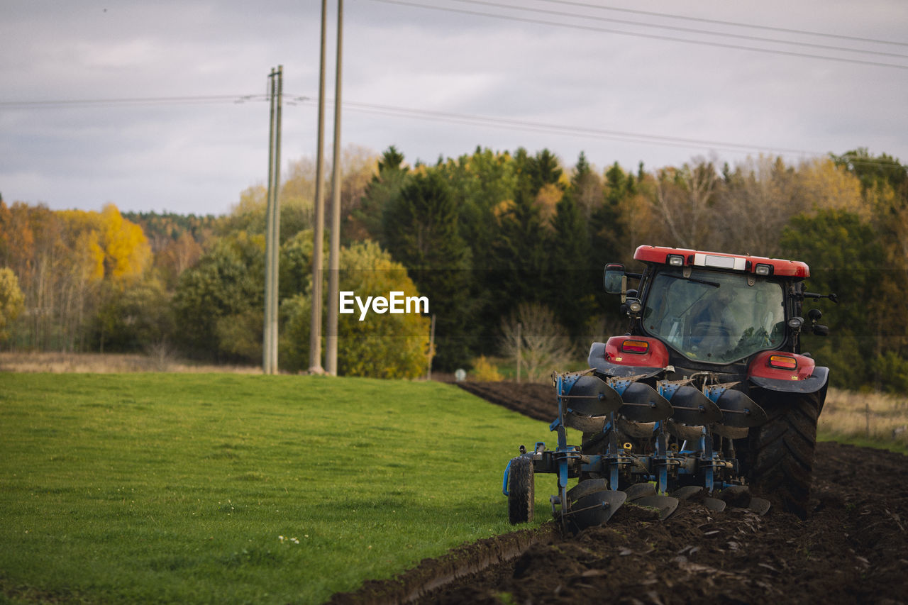 Tractor plowing field at autumn