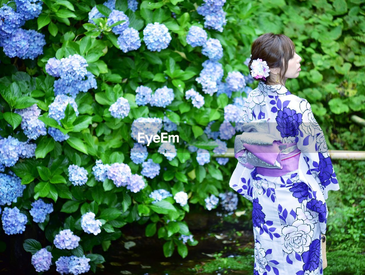 Woman standing on purple flowering plants