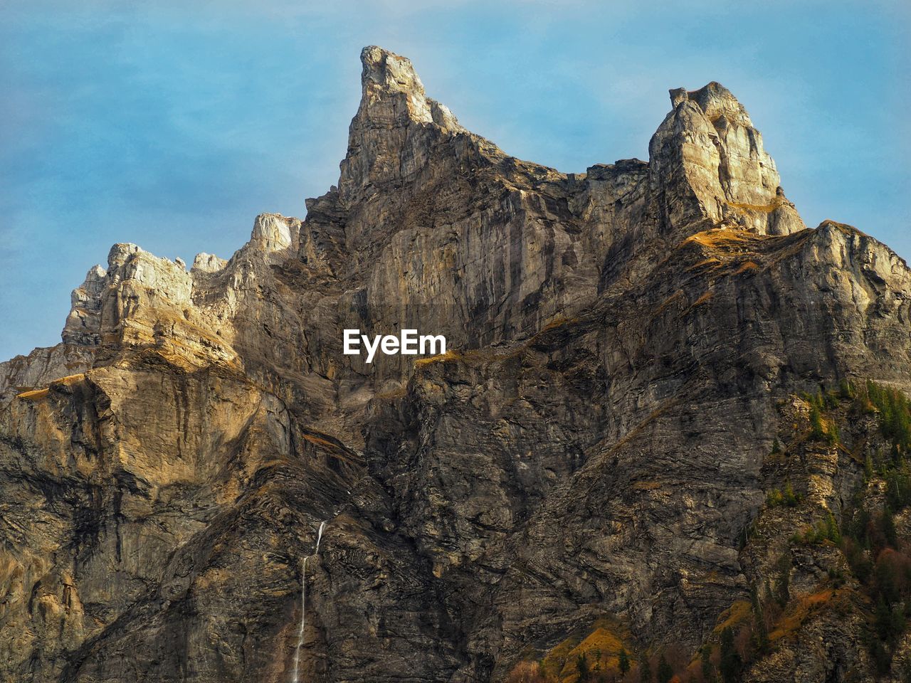 Low angle view of rock formations against sky