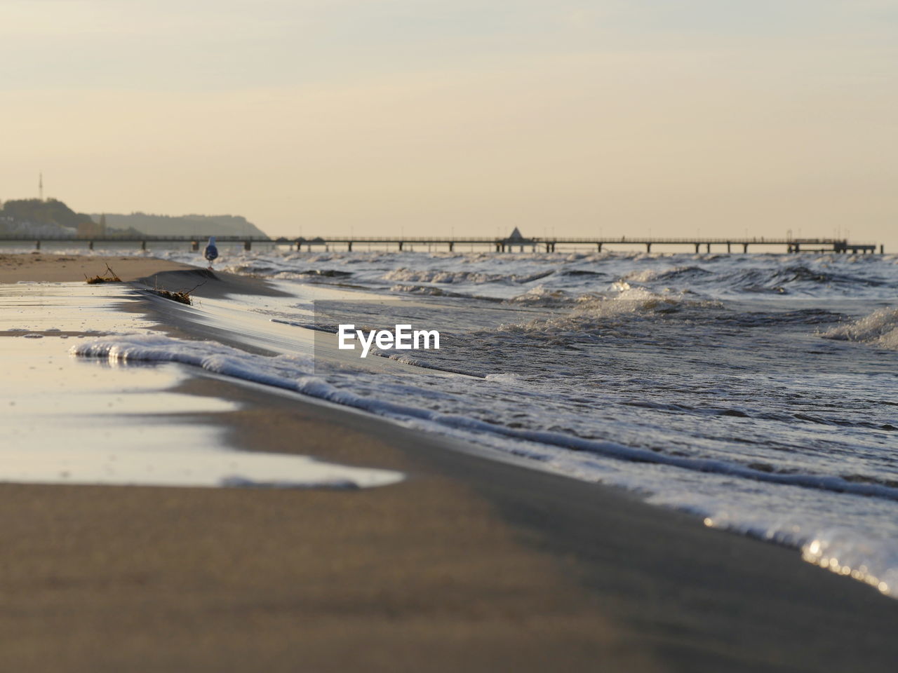 SCENIC VIEW OF BEACH AT SUNSET