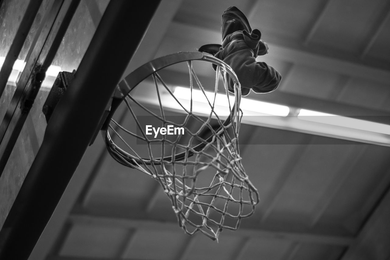 LOW ANGLE VIEW OF BASKETBALL HOOP IN CEILING