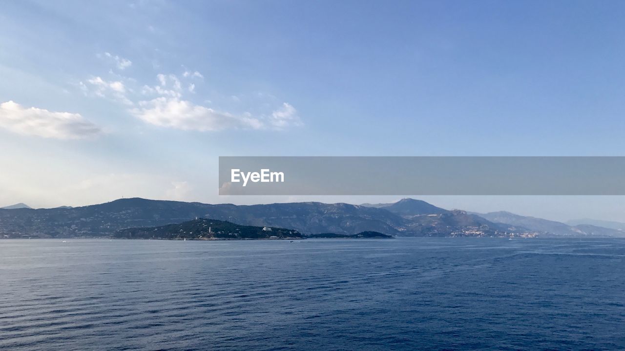 Scenic view of sea against blue sky