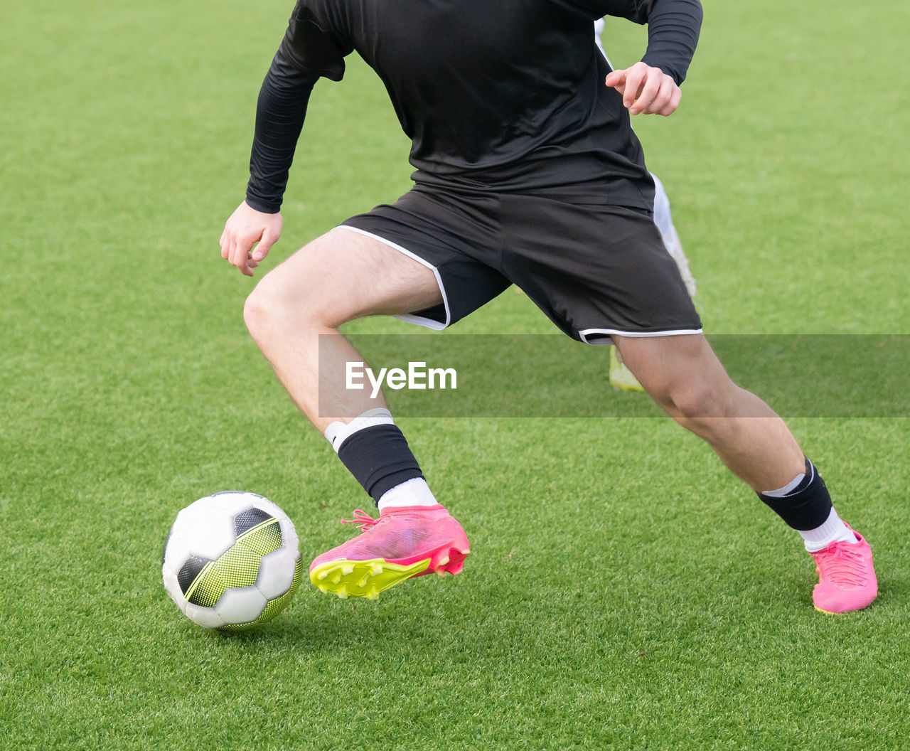 rear view of man playing soccer at park