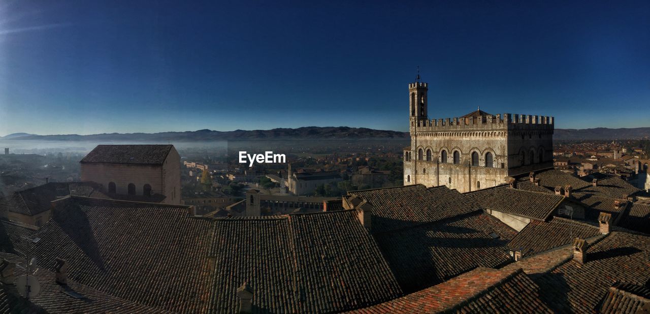 Old buildings in city against clear sky