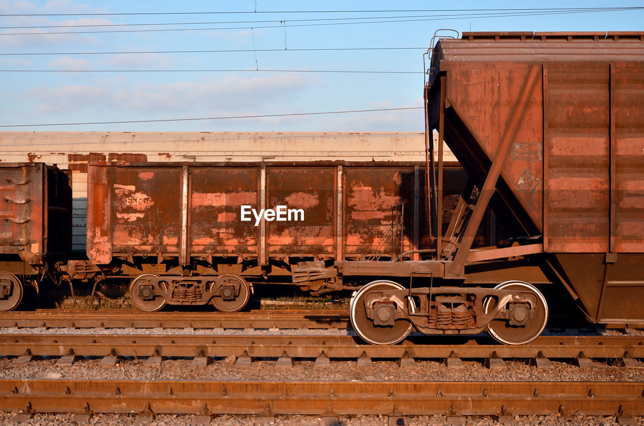 Trains at railroad tracks against sky