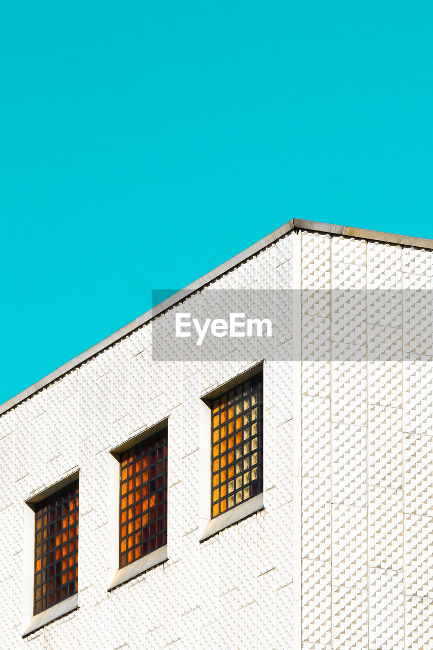 Low angle view of building against clear blue sky