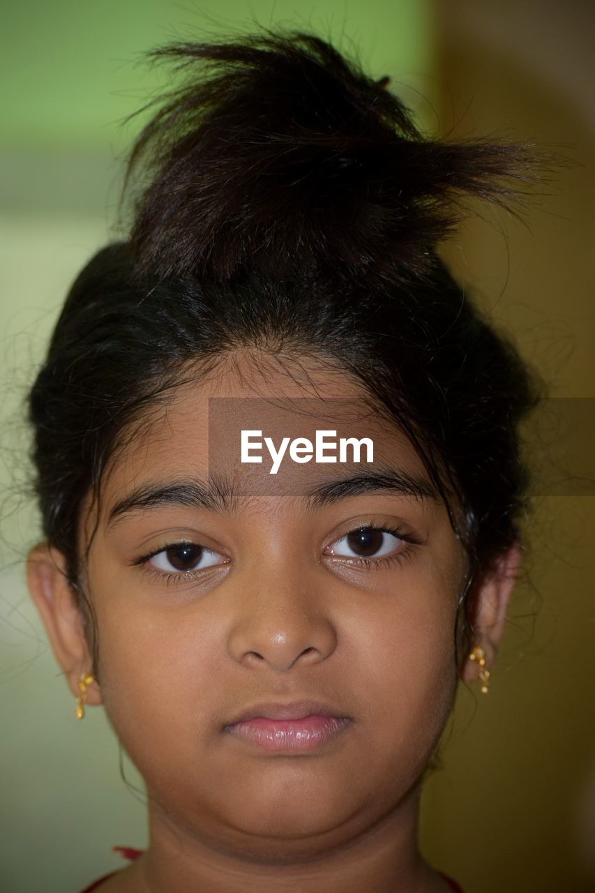 Close-up portrait of girl at home