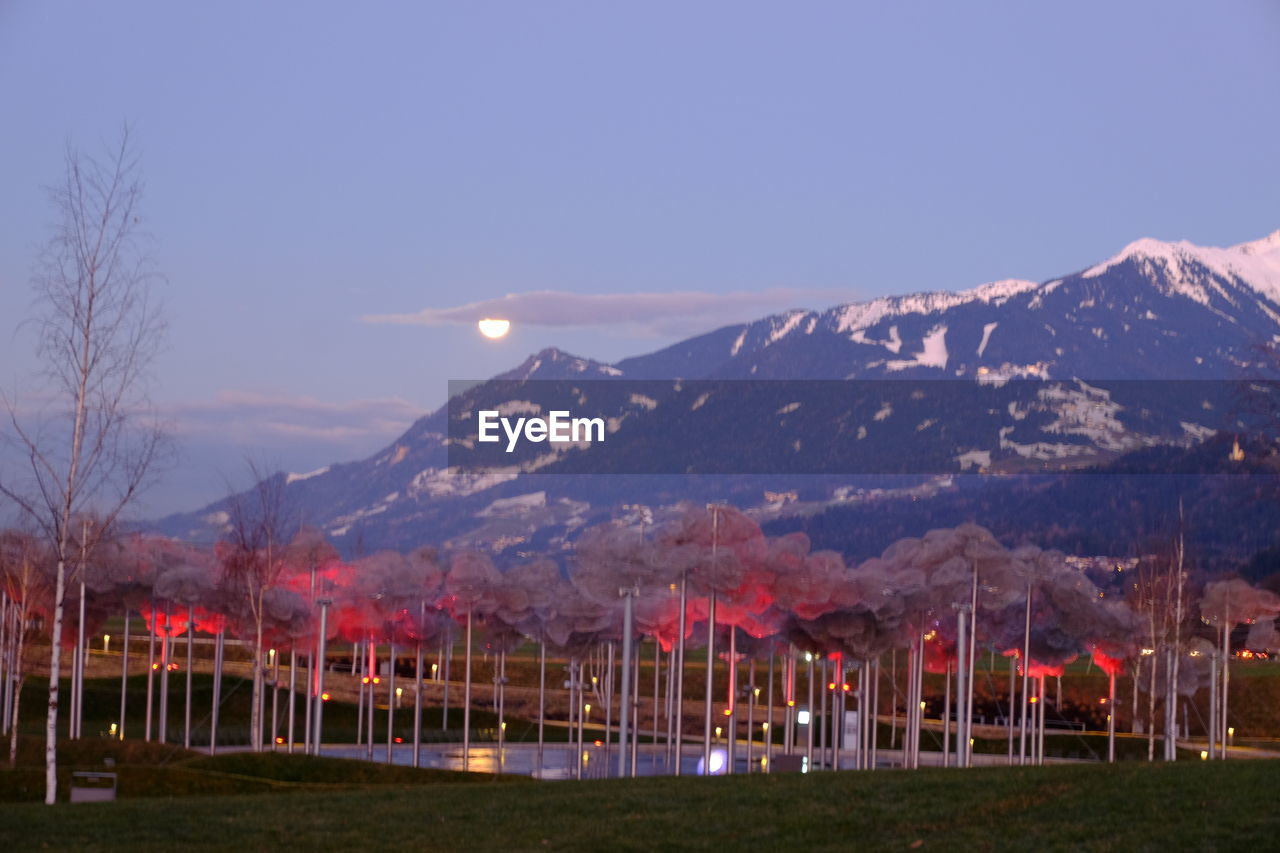 SCENIC VIEW OF MOUNTAINS AGAINST SKY AT DUSK