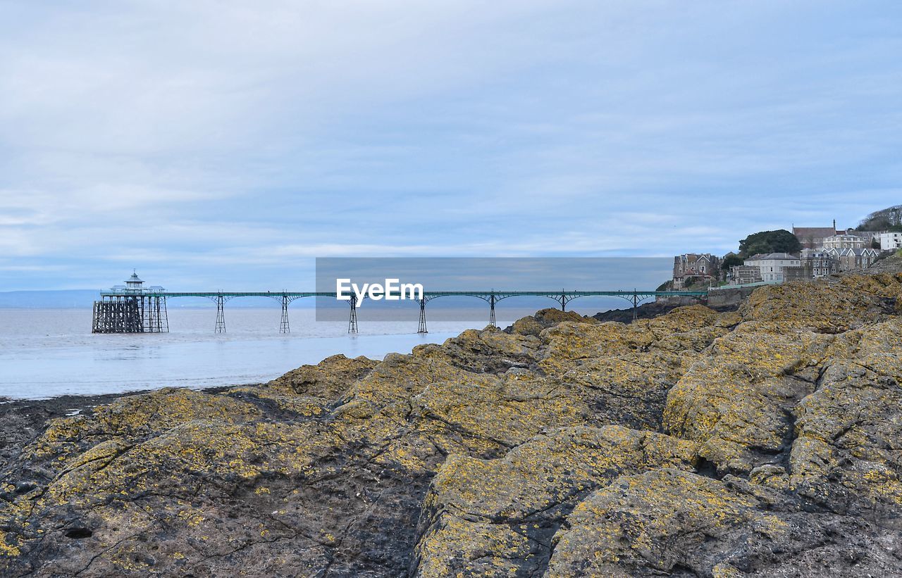 Clevedon pier above the rocks under blue sky