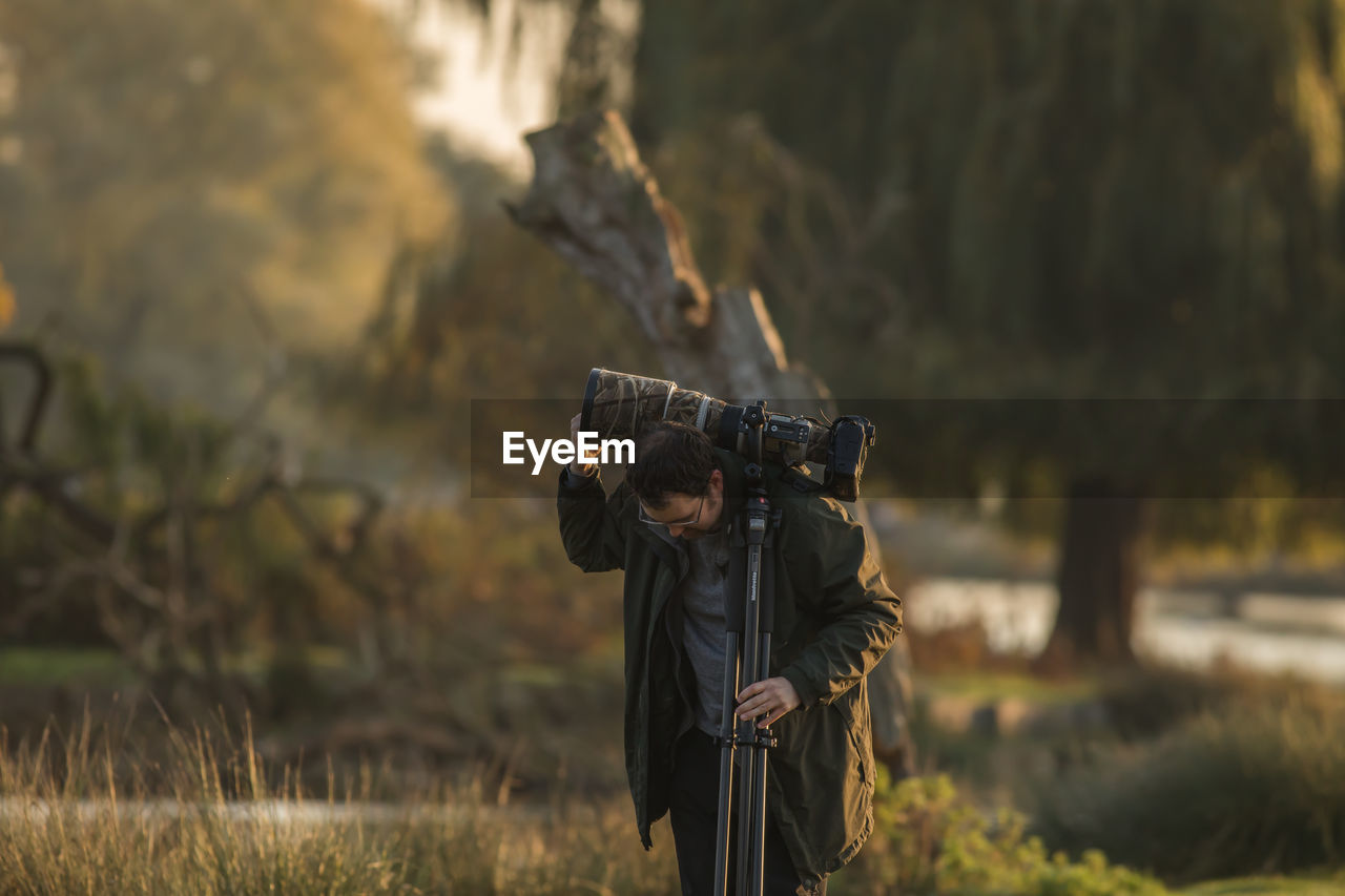 PERSON PHOTOGRAPHING ON FIELD