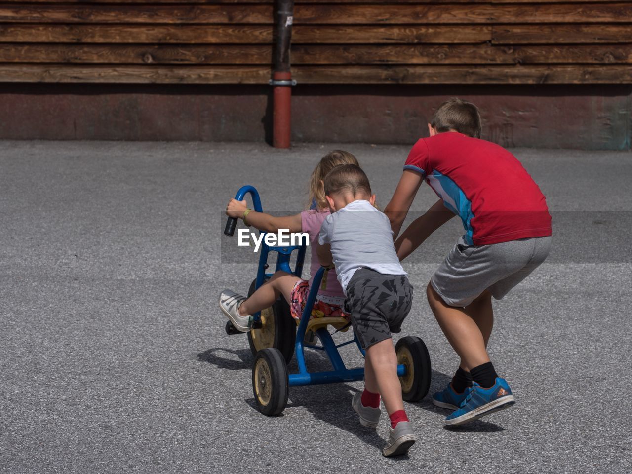 BOY RIDING MOTORCYCLE ON PLAYING WITH BABY