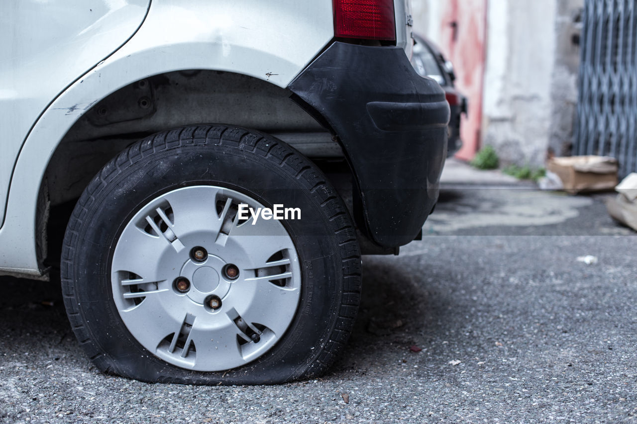 Close-up of car with puncture tire