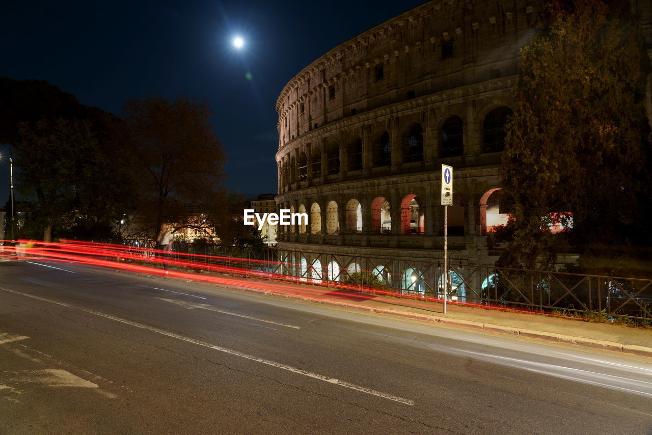 LIGHT TRAILS ON ROAD AT NIGHT