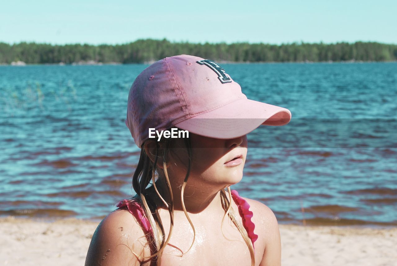 Close-up of girl wearing cap at beach