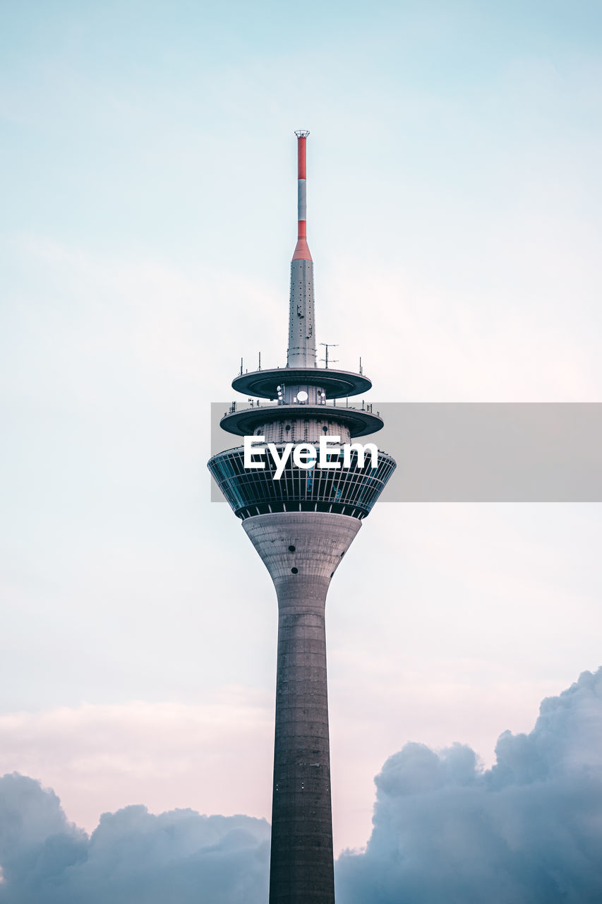  view of the rhinetower in dusseldorf / germany against clear sky with big clouds in the bottom