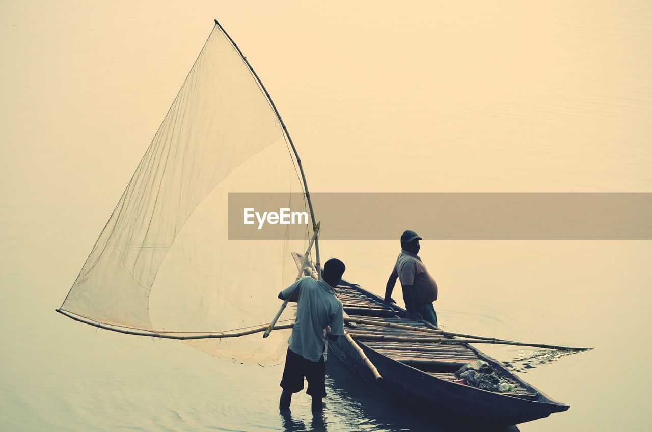 Men with fishing boat in the sea