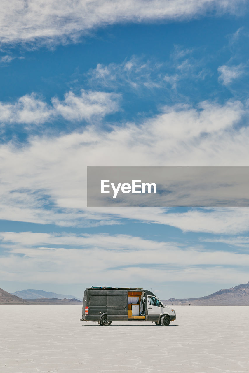 Camper van on bonneville salt flats in utah during a summer road trip.