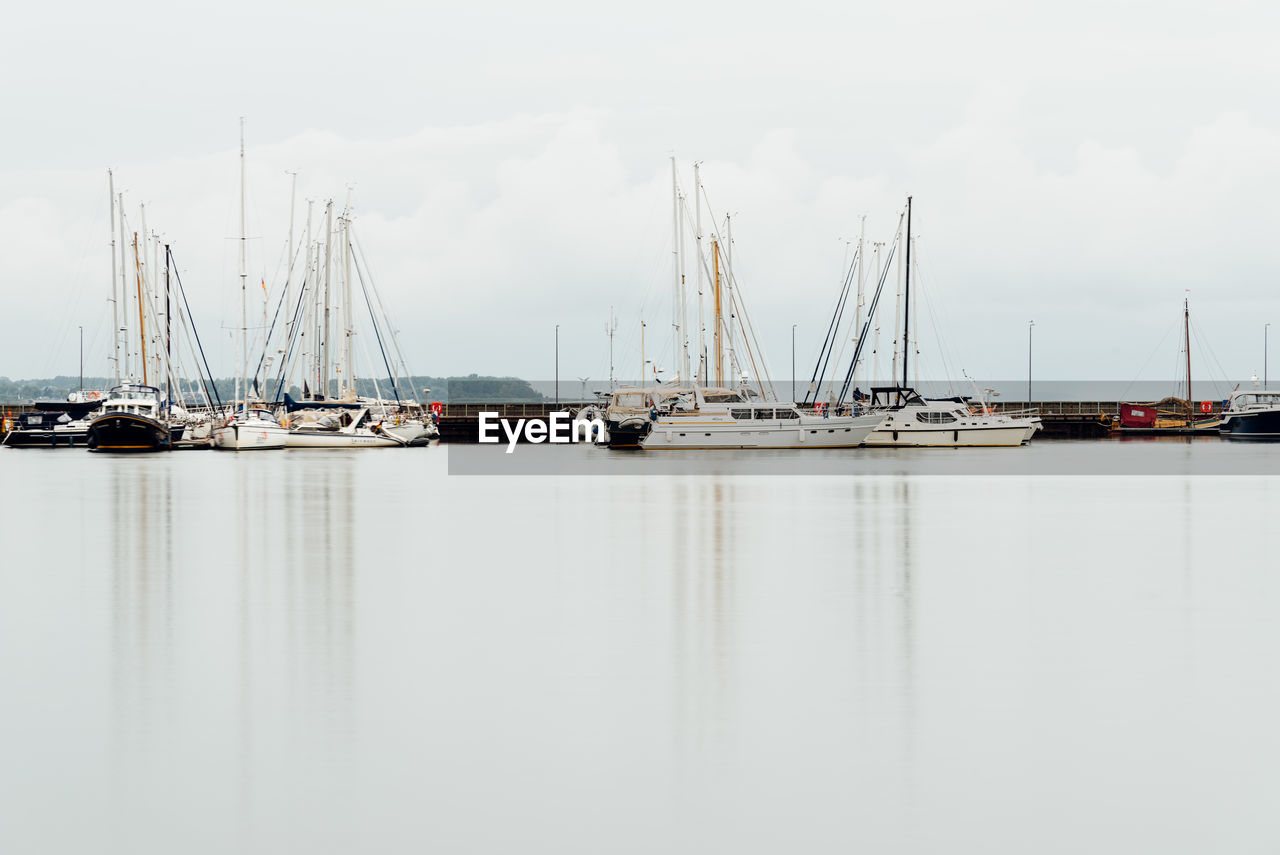 View of the harbour with sailboats moored. long exposure view with reflections on water