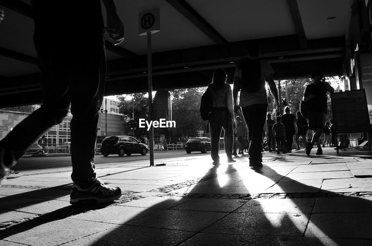 Silhouette people walking on street