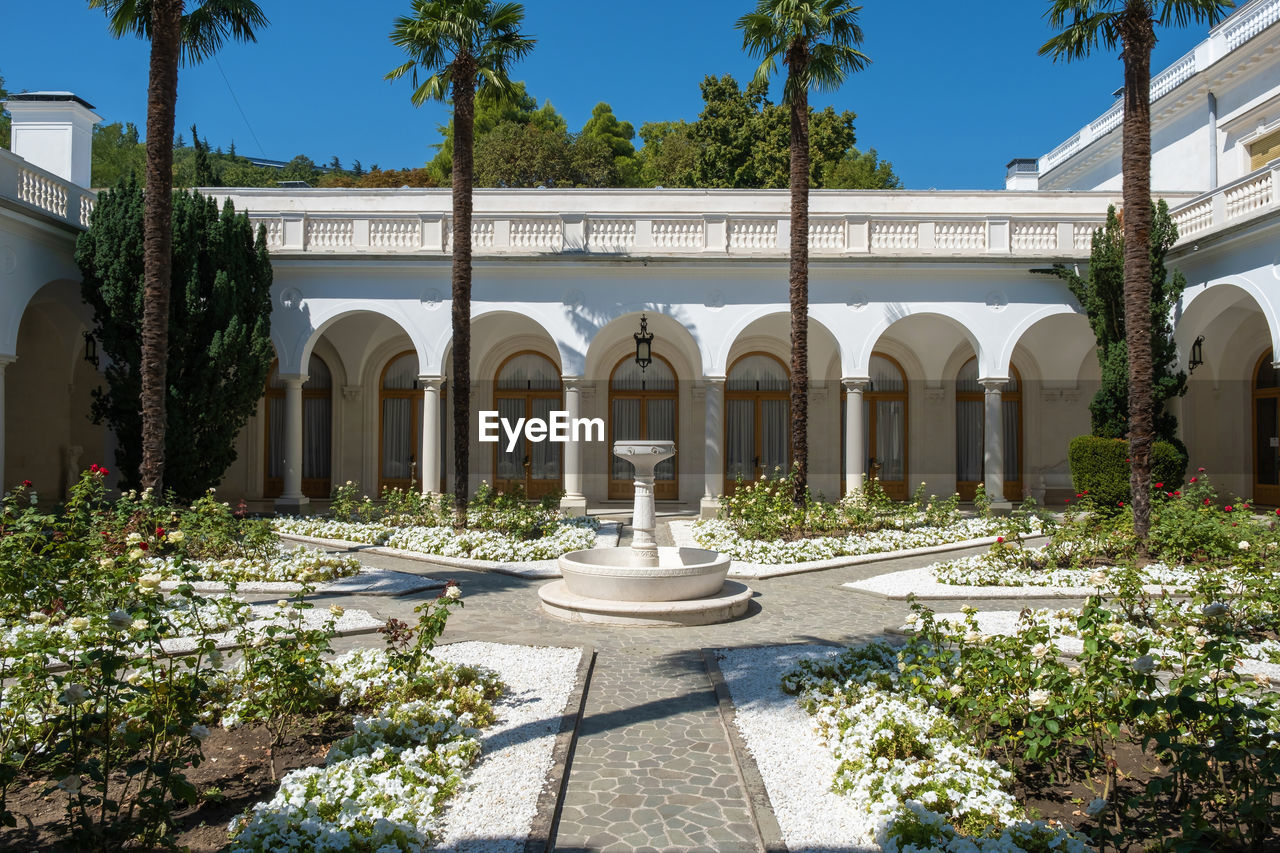 FOUNTAIN AND BUILDING AGAINST SKY