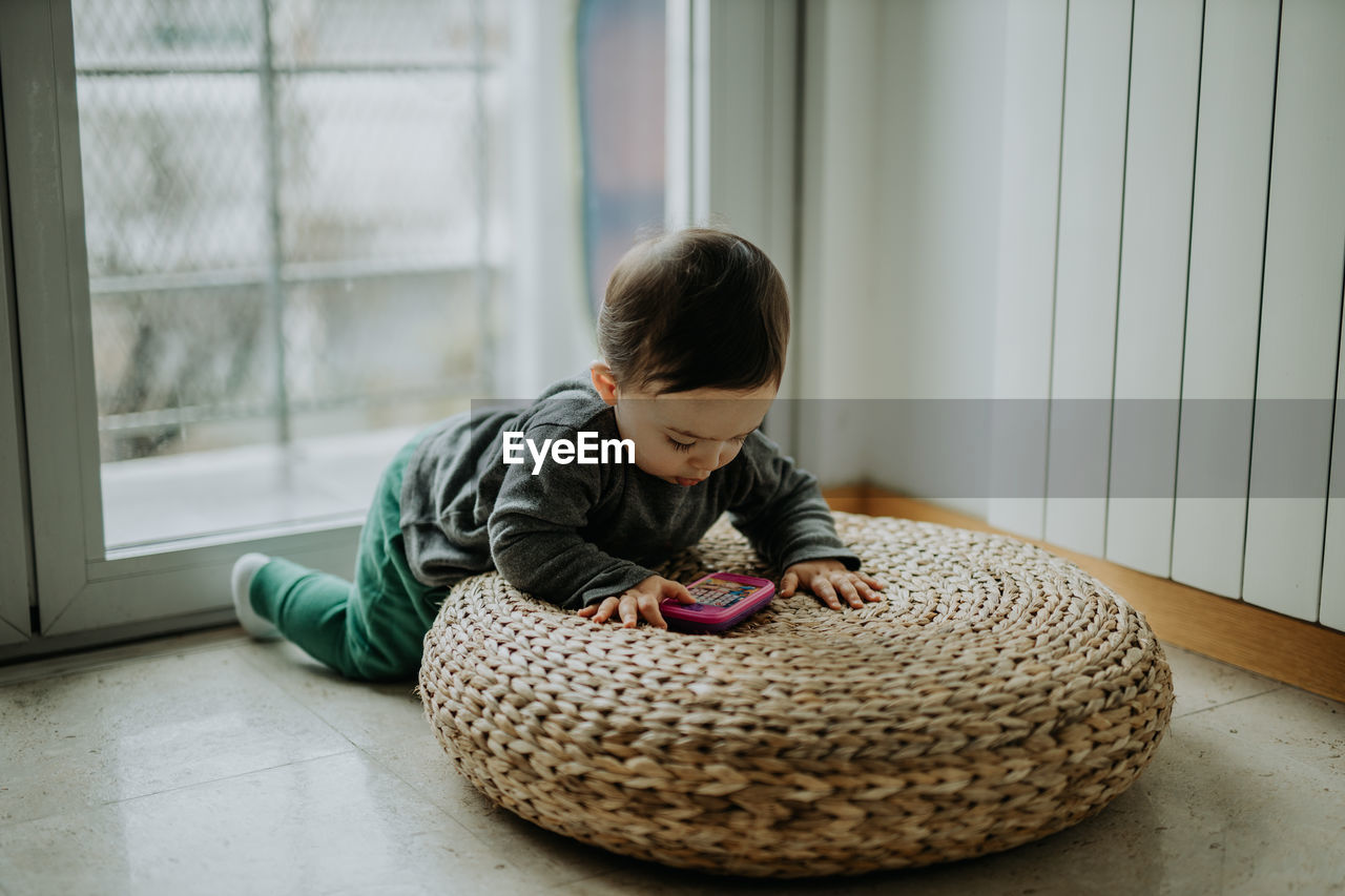 Cute boy playing with toy at home