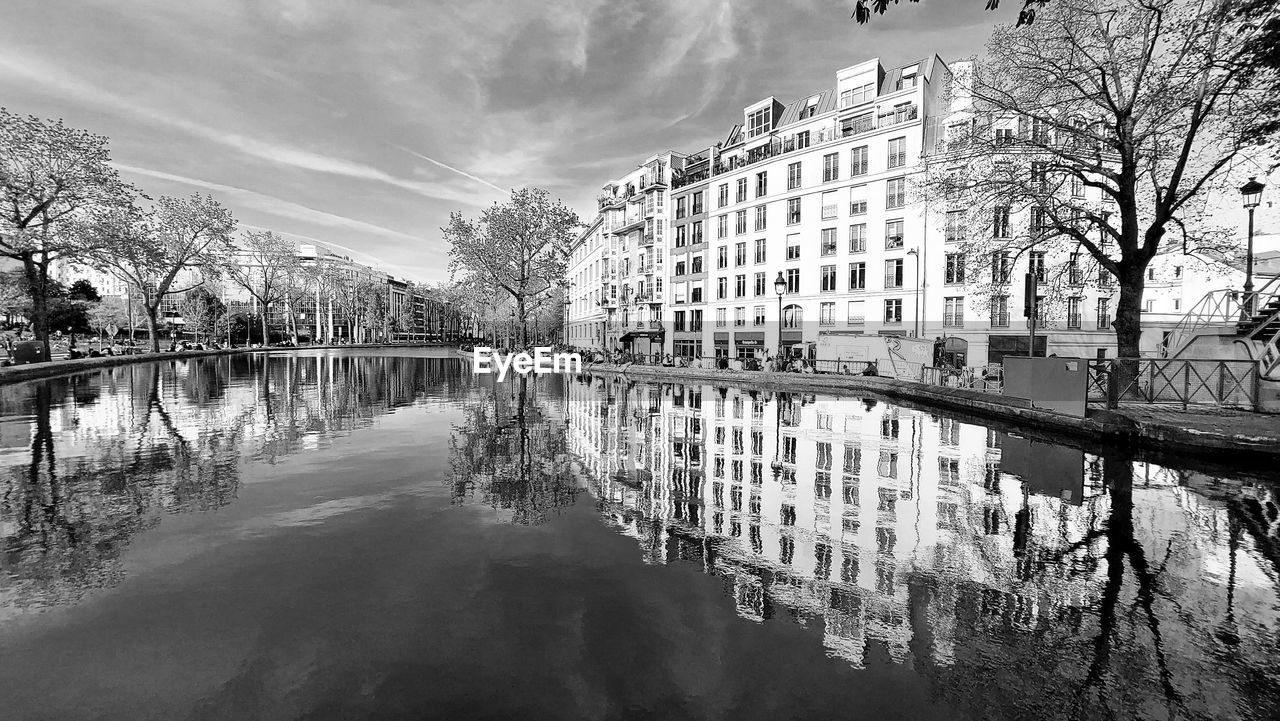 water, reflection, architecture, built structure, tree, building exterior, black and white, nature, city, sky, monochrome photography, monochrome, plant, building, cityscape, cloud, winter, no people, waterway, canal, travel destinations, outdoors, residential district, day, waterfront, morning, urban area, beauty in nature