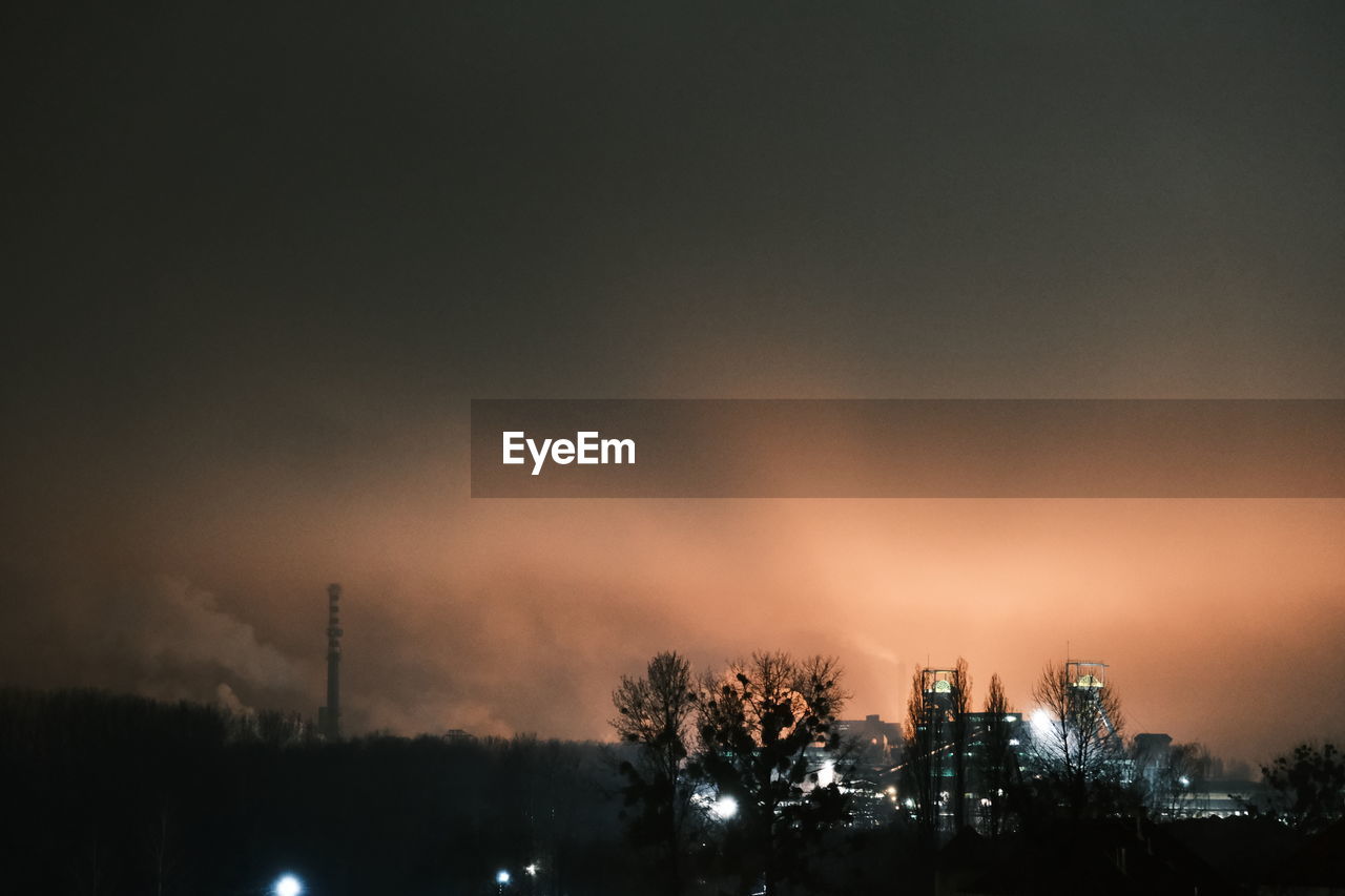 SILHOUETTE OF FACTORY AT SUNSET