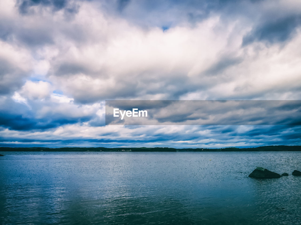 Scenic view of sea against cloudy sky