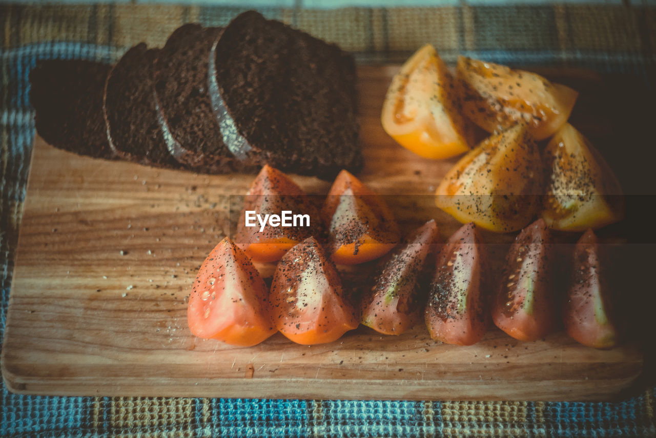 Close up sliced rye bread and spicy tomato pieces concept photo