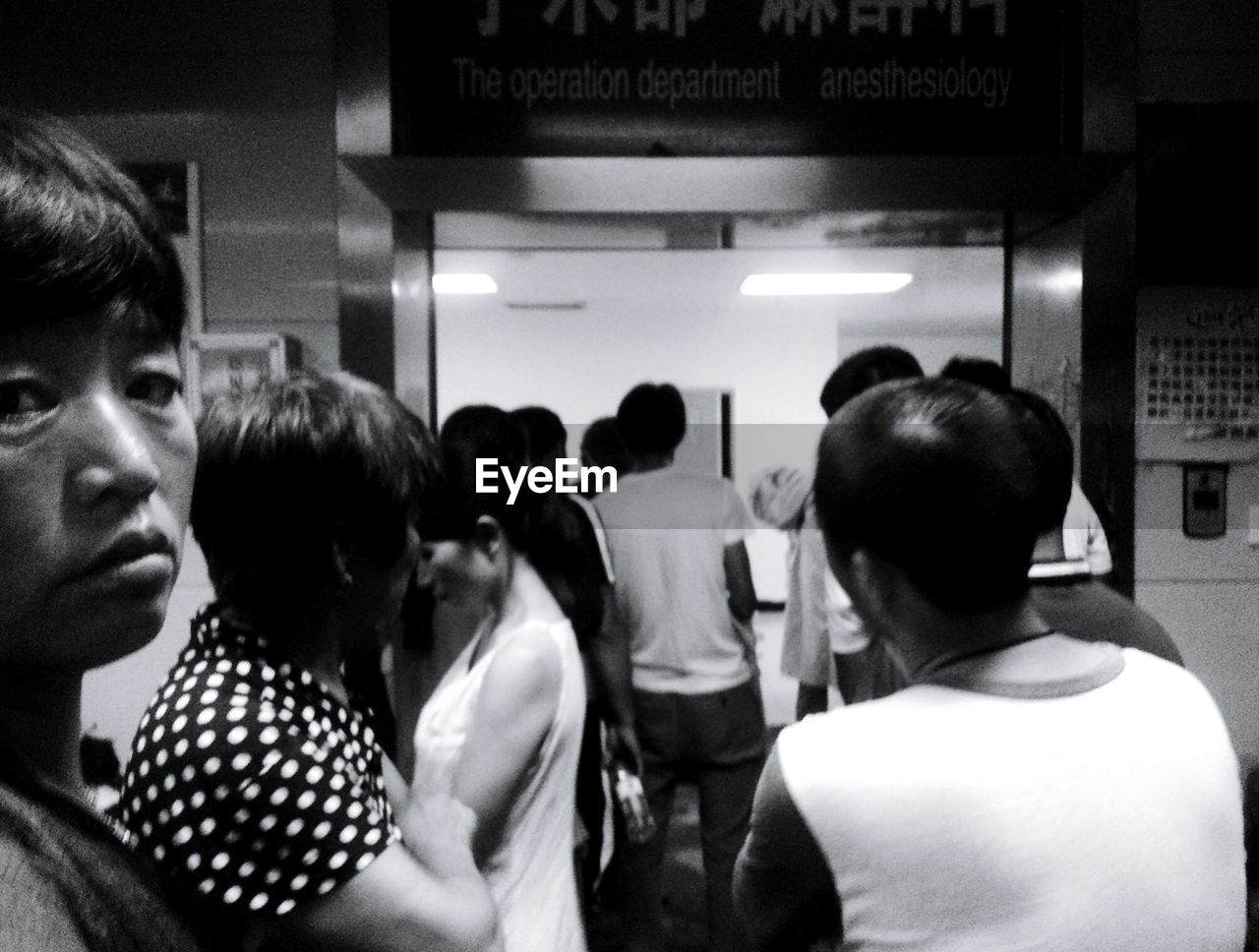 REAR VIEW OF PEOPLE LOOKING AT BUS IN SUBWAY