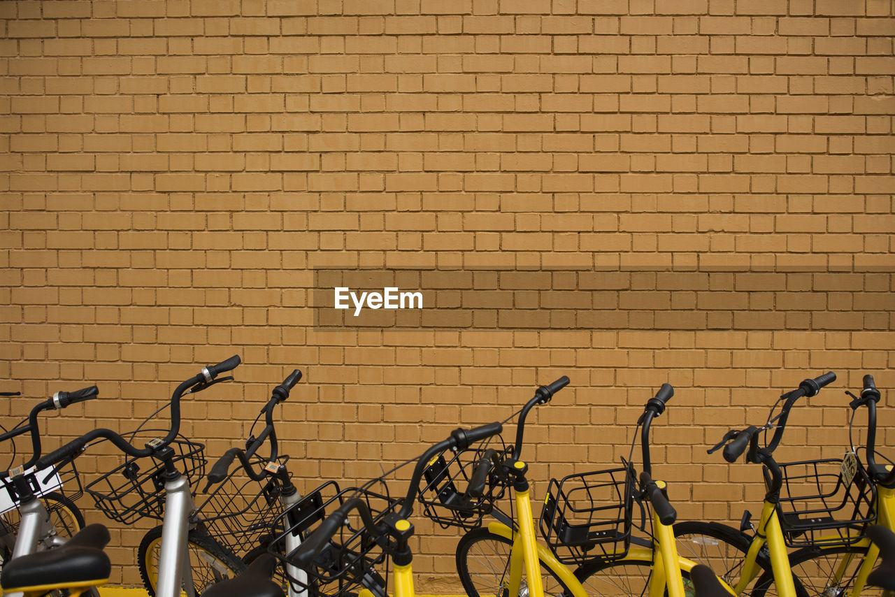 BICYCLE PARKED AGAINST WALL