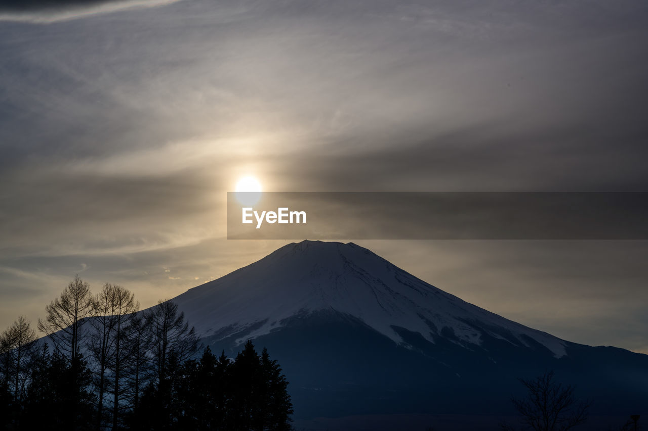 Scenic view of snowcapped mountains against sky during sunset