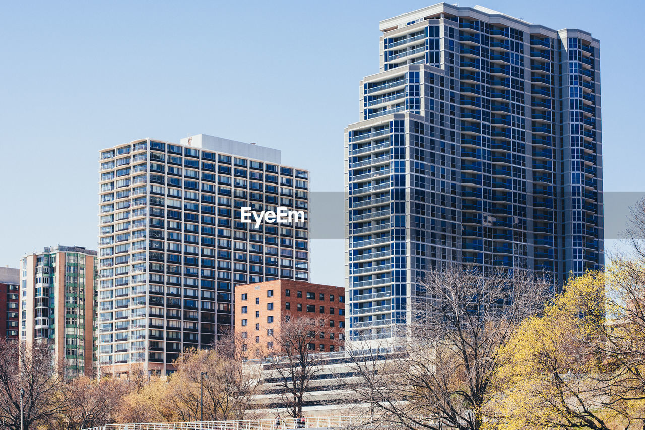 Low angle view of skyscrapers against clear sky