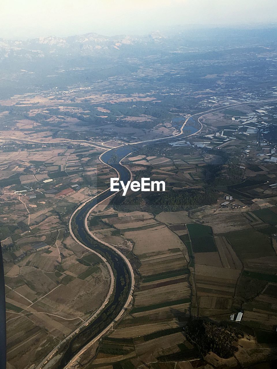 HIGH ANGLE VIEW OF ROAD PASSING THROUGH LAND