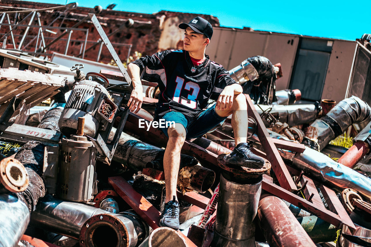 MAN SITTING ON BICYCLE IN TRADITIONAL CLOTHING