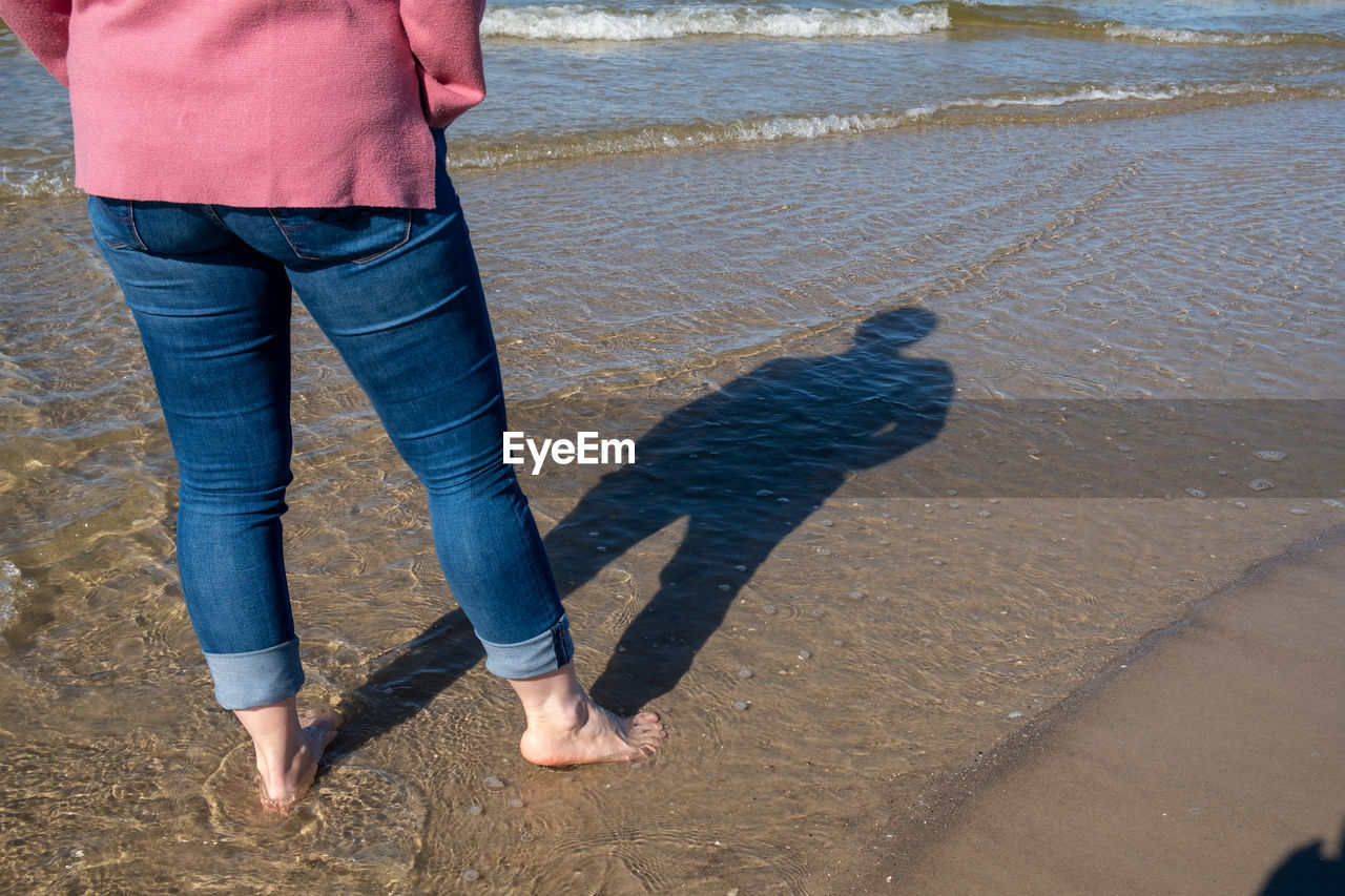 LOW SECTION OF PERSON ON BEACH