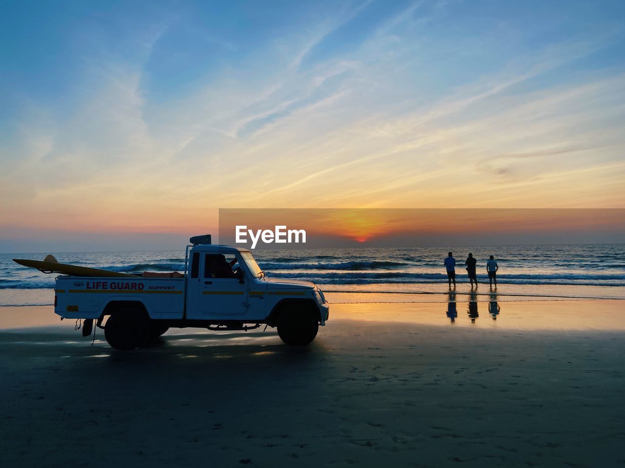 Scenic view of beach against sky during sunset