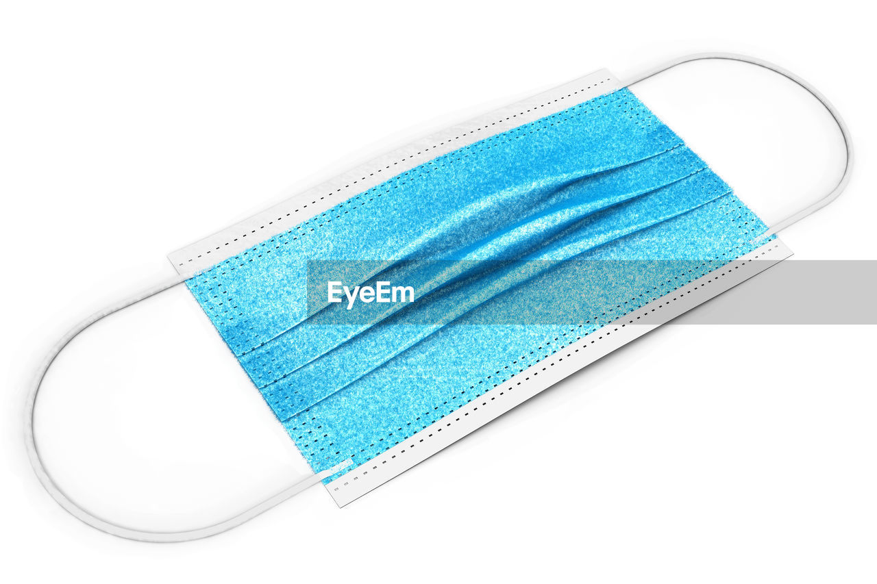 HIGH ANGLE VIEW OF BLUE PAPER AGAINST WHITE BACKGROUND