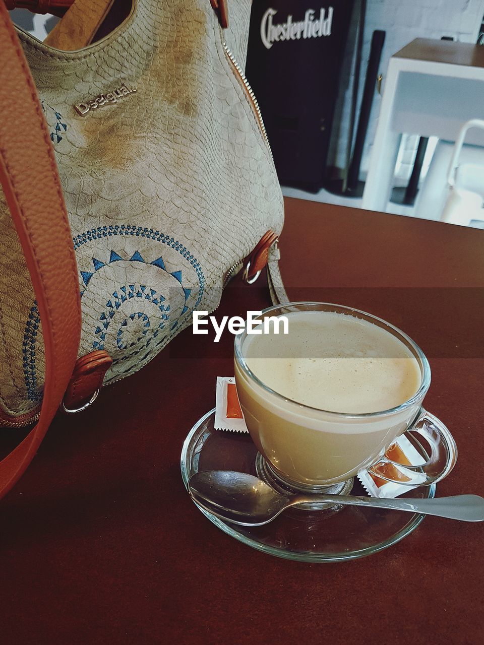 CLOSE-UP OF COFFEE CUP AND TABLE