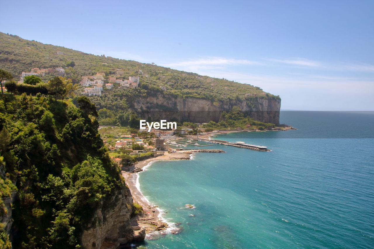 Scenic view of sea and mountains against sky